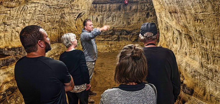 Photo of individuals in a cave