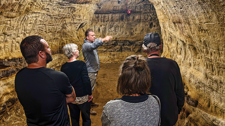 Photo of individuals in a cave