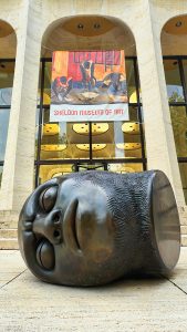 a sculpture of a head outside the Sheldon Art Museum