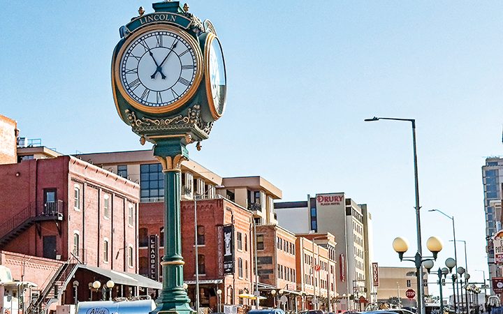 an ornate clock in a busy downtown area