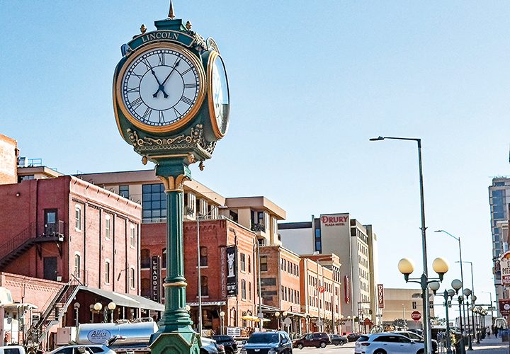 an ornate clock in a busy downtown area