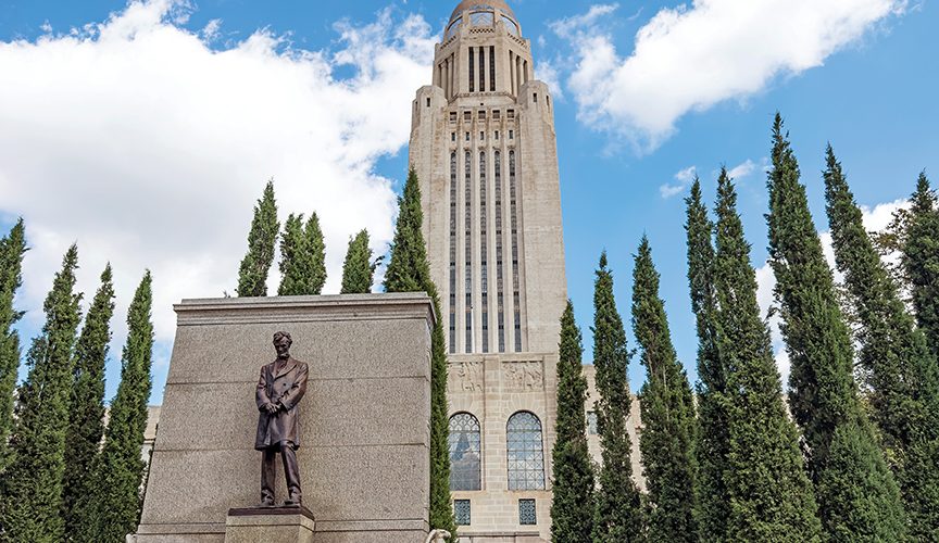 a picture of the Abraham Lincoln statue outside the Nebraska State Capitol building.