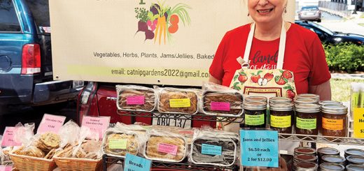 a person stands in front of their market stall