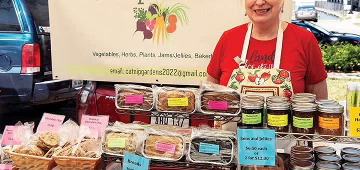 a person stands in front of their market stall