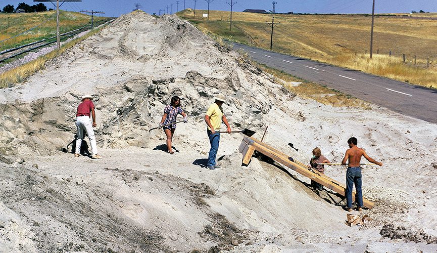 Workers at an archaeological site digging.