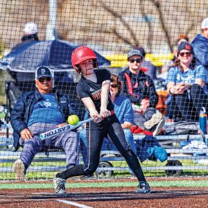 A young person playing baseball in a uniform