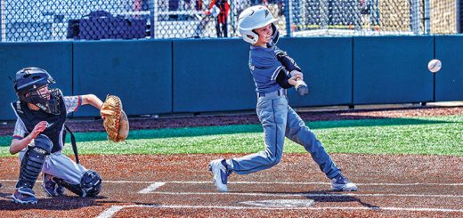 A child playing baseball in a uniform