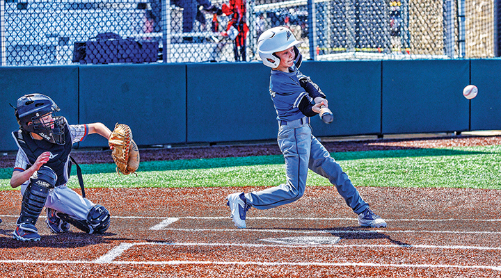 A child playing baseball in a uniform