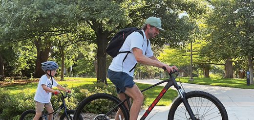 A man and a child on bikes outdoots