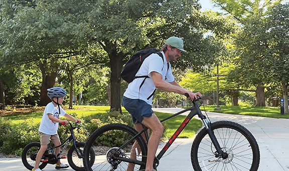 A man and a child on bikes outdoots