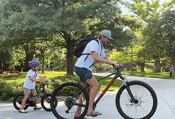 A man and a child on bikes outdoots